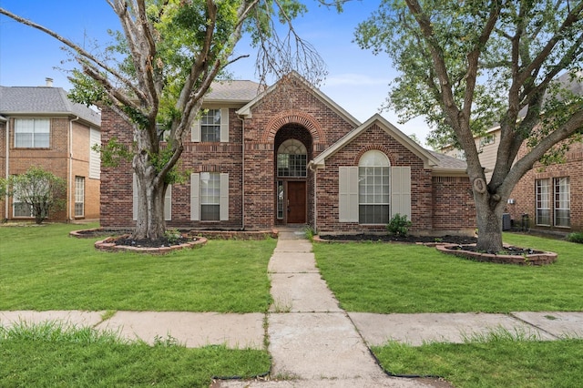 15306 Goodman St, Houston, TX 77084 - traditional home featuring brick siding, a front lawn, and roof with shingles