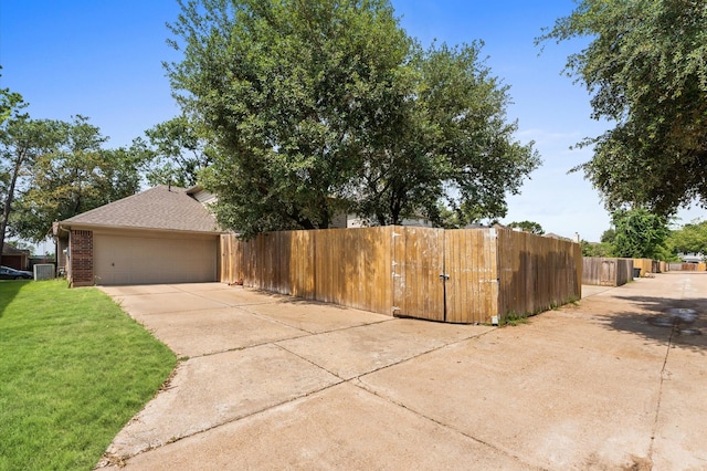 15306 Goodman St, Houston, TX 77084 - view of property exterior with cooling unit, brick siding, roof with shingles, driveway, and a gate