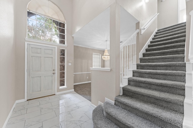 15306 Goodman St, Houston, TX 77084 - foyer with stairs, marble look tiles, and baseboards