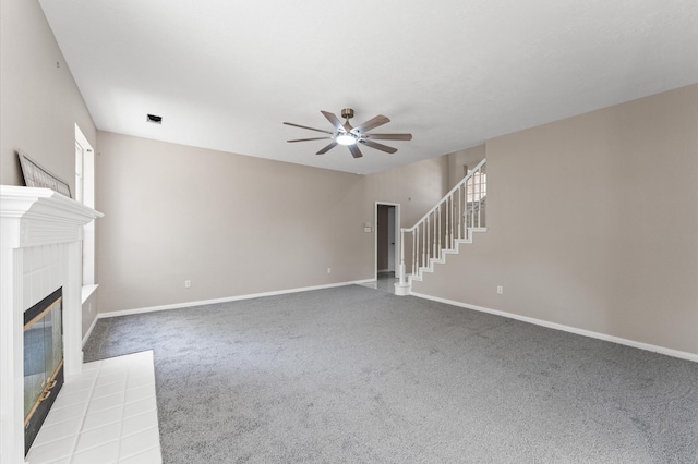 15306 Goodman St, Houston, TX 77084 - unfurnished living room with ceiling fan, carpet flooring, stairs, and baseboards