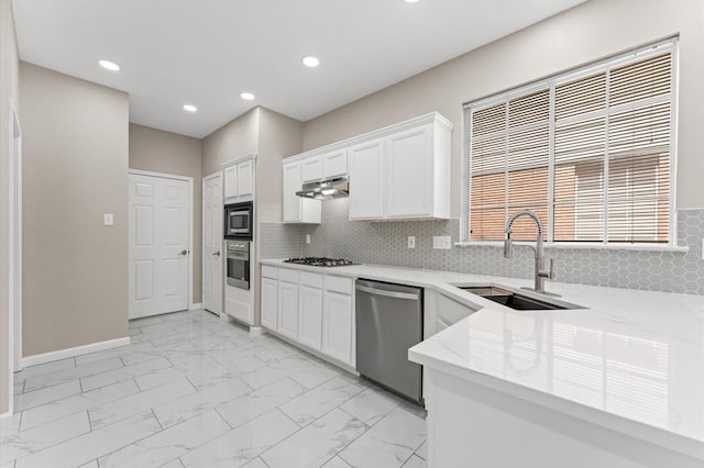 15306 Goodman St, Houston, TX 77084 - kitchen with appliances with stainless steel finishes, a sink, light marble finish floors, under cabinet range hood, and light stone counters