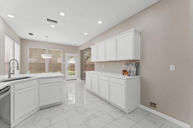 15306 Goodman St, Houston, TX 77084 - kitchen featuring a sink, stainless steel dishwasher, recessed lighting, light marble finish floors, and baseboards