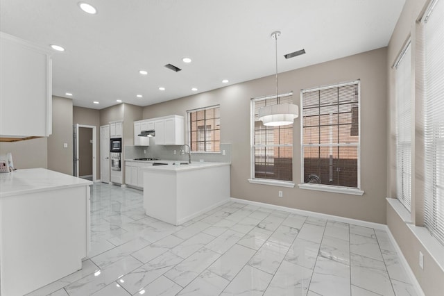 15306 Goodman St, Houston, TX 77084 - kitchen featuring light countertops, light marble finish flooring, white cabinetry, baseboards, and recessed lighting