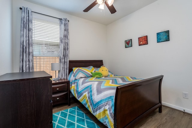 7702 Royal Oasis Ln, Cypress, TX 77433 - bedroom with ceiling fan, baseboards, and wood finished floors