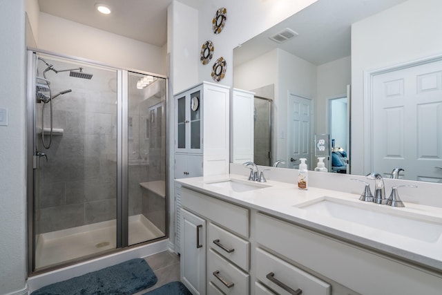 7702 Royal Oasis Ln, Cypress, TX 77433 - full bath featuring visible vents, a sink, a shower stall, and double vanity