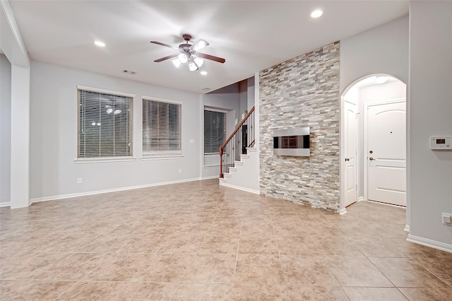 unfurnished living room featuring stairway, light tile patterned flooring, ceiling fan, visible vents, and recessed lighting