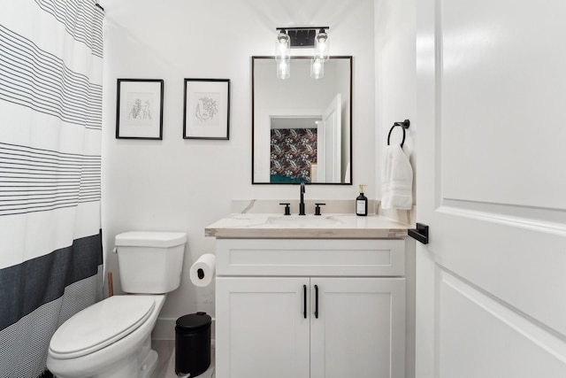 full bathroom with toilet and vanity