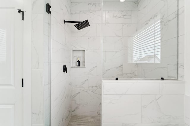 bathroom with a marble finish shower
