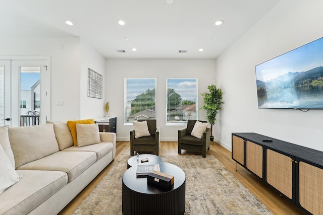 living area featuring visible vents, recessed lighting, and light wood-style floors