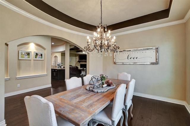 12603 Mostyn Ct, Magnolia, TX 77354 - dining area featuring arched walkways, baseboards, dark wood finished floors, and an inviting chandelier