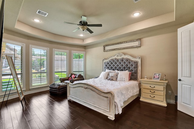 12603 Mostyn Ct, Magnolia, TX 77354 - bedroom featuring a raised ceiling, baseboards, dark wood-type flooring, and visible vents
