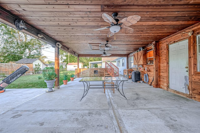 view of patio featuring a storage shed, a ceiling fan, fence, and an outdoor structure