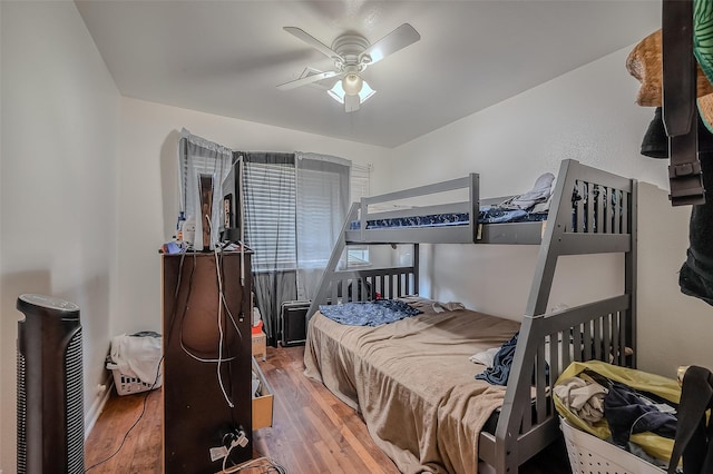 bedroom featuring a ceiling fan and wood finished floors