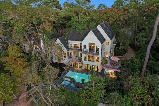 2003 Arrowwood Cir N, Houston, TX 77063 - back of property with fence, a patio area, a balcony, and a pool with connected hot tub