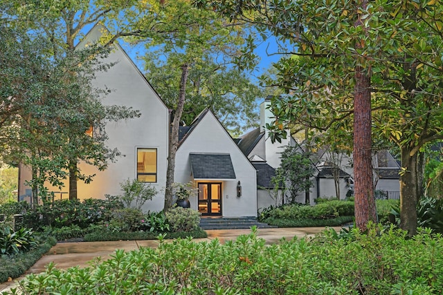 2003 Arrowwood Cir N, Houston, TX 77063 - view of front facade featuring stucco siding, a shingled roof, and french doors
