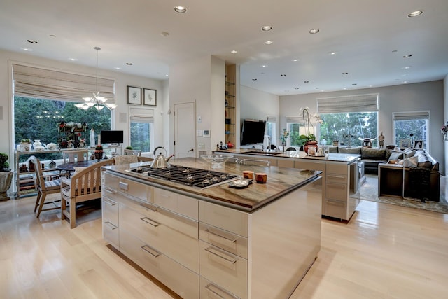 2003 Arrowwood Cir N, Houston, TX 77063 - kitchen with a spacious island, modern cabinets, stainless steel gas stovetop, and open floor plan