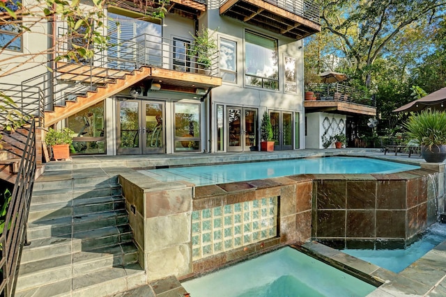 2003 Arrowwood Cir N, Houston, TX 77063 - rear view of house with french doors, a balcony, an outdoor pool, and stairs