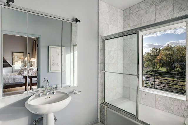 2003 Arrowwood Cir N, Houston, TX 77063 - ensuite bathroom featuring a healthy amount of sunlight, ensuite bathroom, and shower / bath combination with glass door