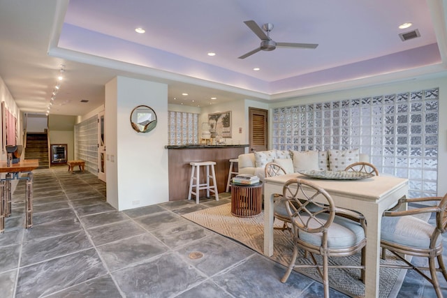 2003 Arrowwood Cir N, Houston, TX 77063 - dining room with a dry bar, visible vents, a ceiling fan, and a tray ceiling