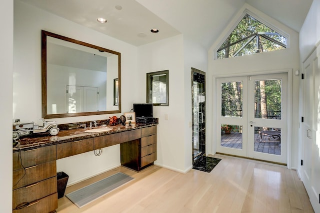 2003 Arrowwood Cir N, Houston, TX 77063 - full bath featuring french doors, baseboards, vaulted ceiling, wood finished floors, and vanity
