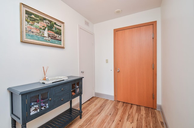foyer entrance with light wood-type flooring and visible vents