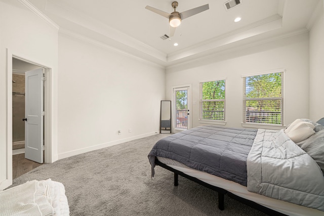 bedroom featuring baseboards, crown molding, visible vents, and a raised ceiling