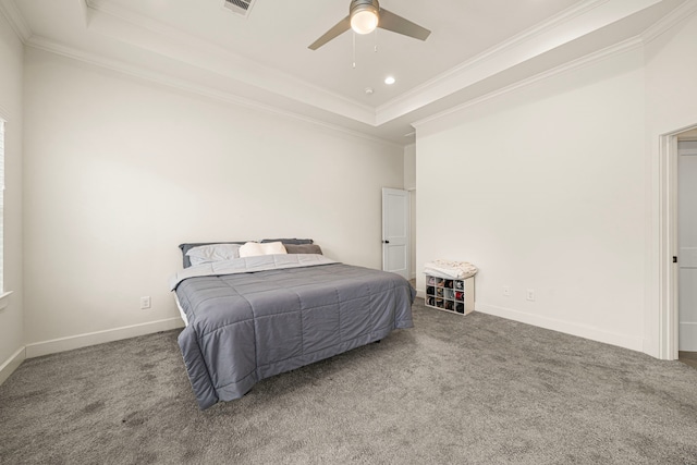 bedroom with a raised ceiling, carpet floors, crown molding, and baseboards