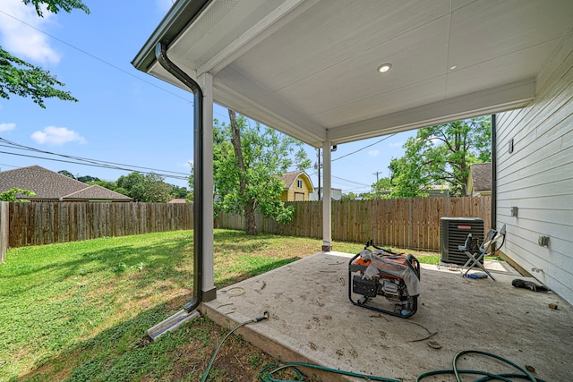 view of yard featuring a patio, central AC, and a fenced backyard