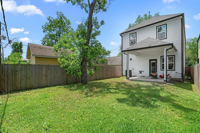 back of house featuring a lawn, a fenced backyard, central AC unit, and a patio