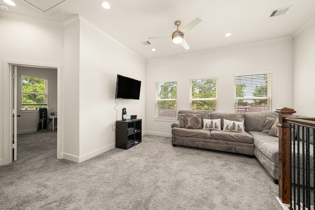 carpeted living room with attic access, ceiling fan, baseboards, and visible vents