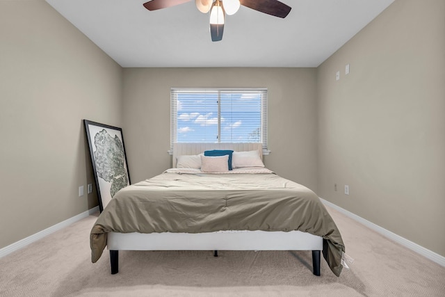 bedroom featuring baseboards, ceiling fan, and light carpet