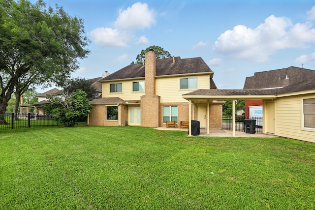back of property with a yard, a patio, and fence
