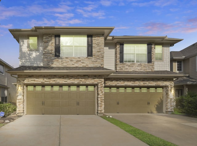 view of front of house with an attached garage, stone siding, and concrete driveway