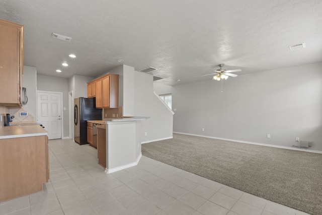 kitchen featuring light carpet, open floor plan, visible vents, and freestanding refrigerator