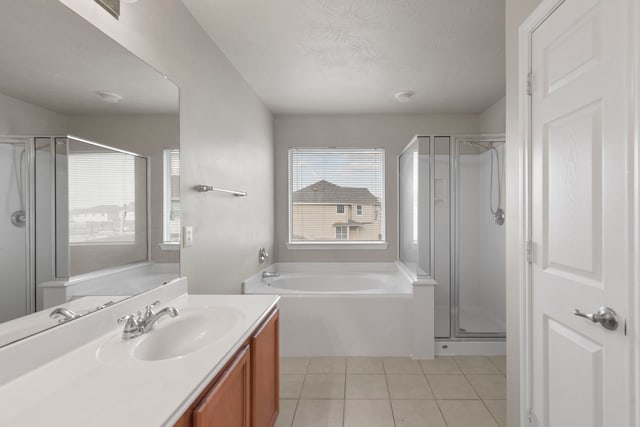 full bathroom featuring a shower stall, a garden tub, tile patterned flooring, and vanity