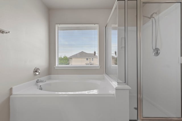 bathroom with a garden tub and a stall shower