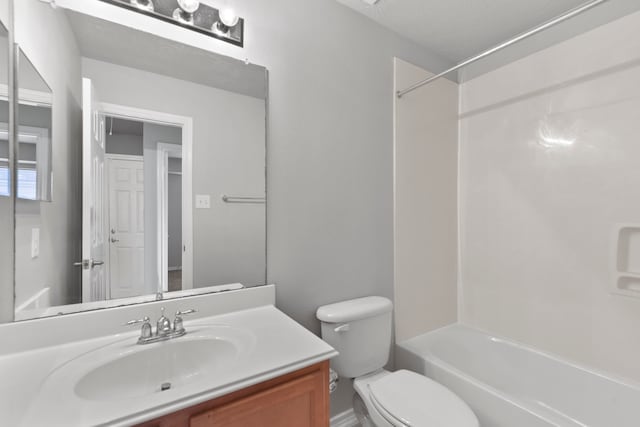 bathroom with shower / washtub combination, toilet, and vanity