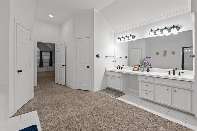 full bath with carpet, tile patterned flooring, a sink, and crown molding