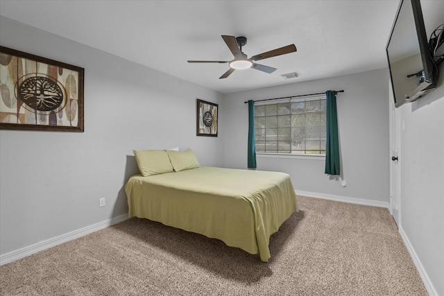 bedroom featuring baseboards, ceiling fan, visible vents, and carpet