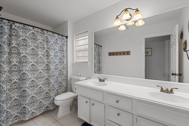 bathroom featuring toilet, tile patterned floors, double vanity, and a sink