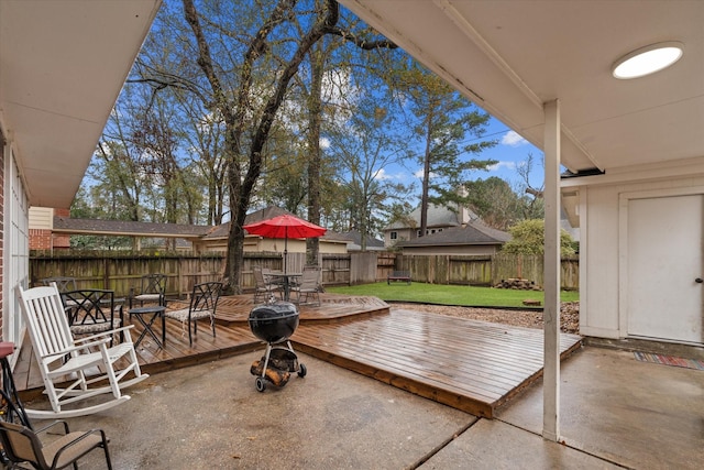 view of patio featuring a deck, outdoor dining space, and a fenced backyard