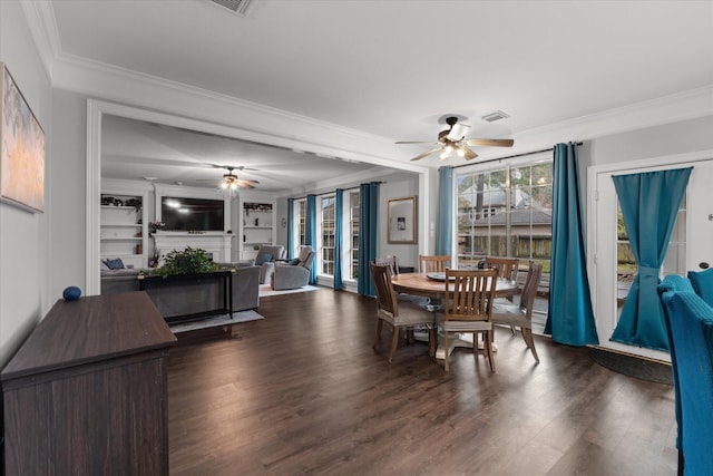 dining room with ornamental molding, a ceiling fan, visible vents, and dark wood finished floors