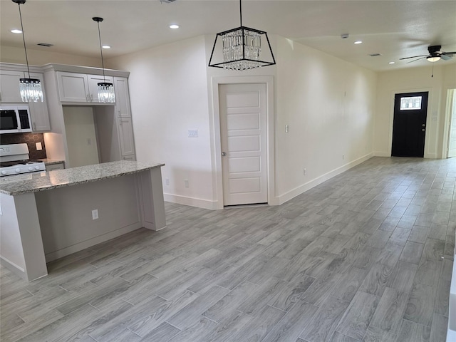 2140 De Soto St, Houston, TX 77091 - kitchen with stainless steel microwave, gas range gas stove, open floor plan, and light wood-type flooring