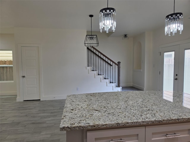 2140 De Soto St, Houston, TX 77091 - entryway featuring a notable chandelier, stairway, wood finished floors, and baseboards