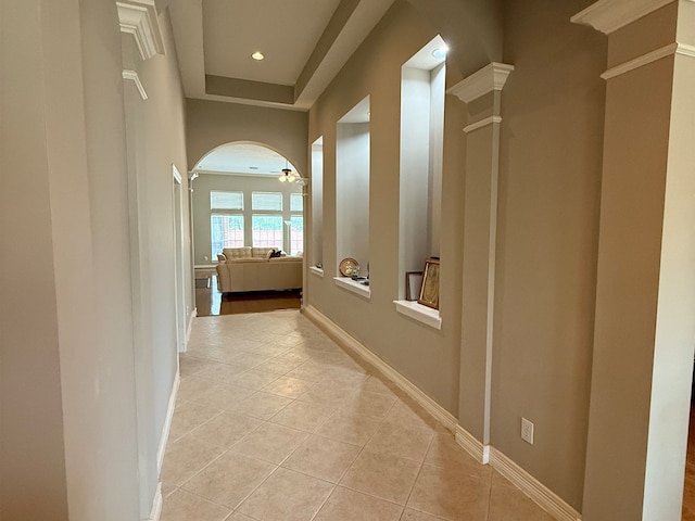 hall featuring ornate columns, recessed lighting, baseboards, and light tile patterned flooring