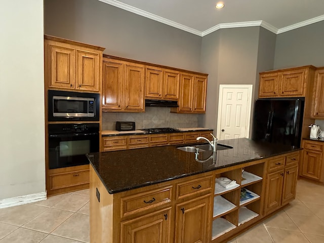 kitchen with tasteful backsplash, light tile patterned floors, black appliances, and brown cabinets
