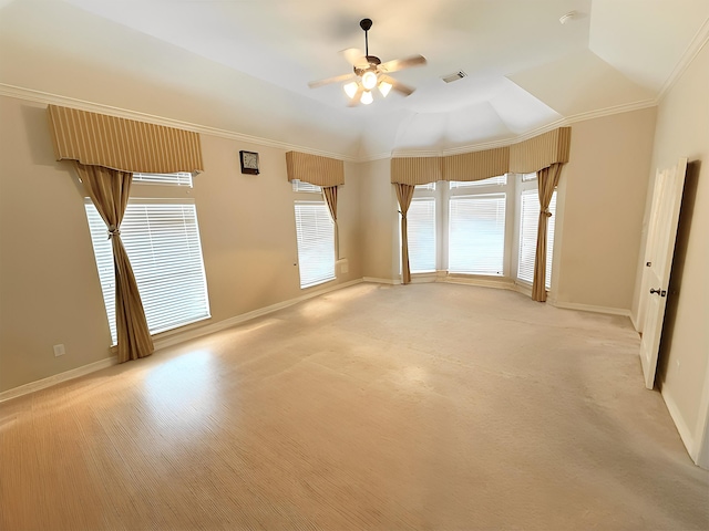 empty room featuring visible vents, ornamental molding, baseboards, and ceiling fan