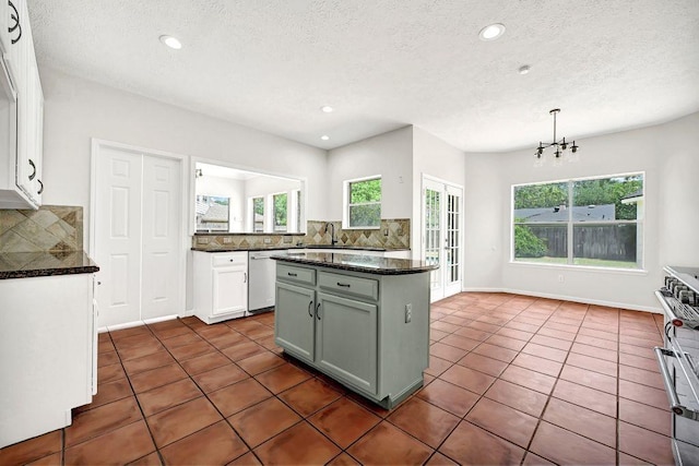 kitchen featuring a textured ceiling, backsplash, and appliances with stainless steel finishes