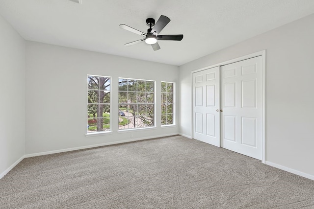 unfurnished bedroom with baseboards, a closet, and carpet