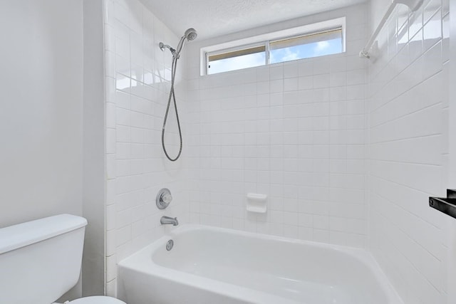 bathroom featuring bathtub / shower combination and toilet